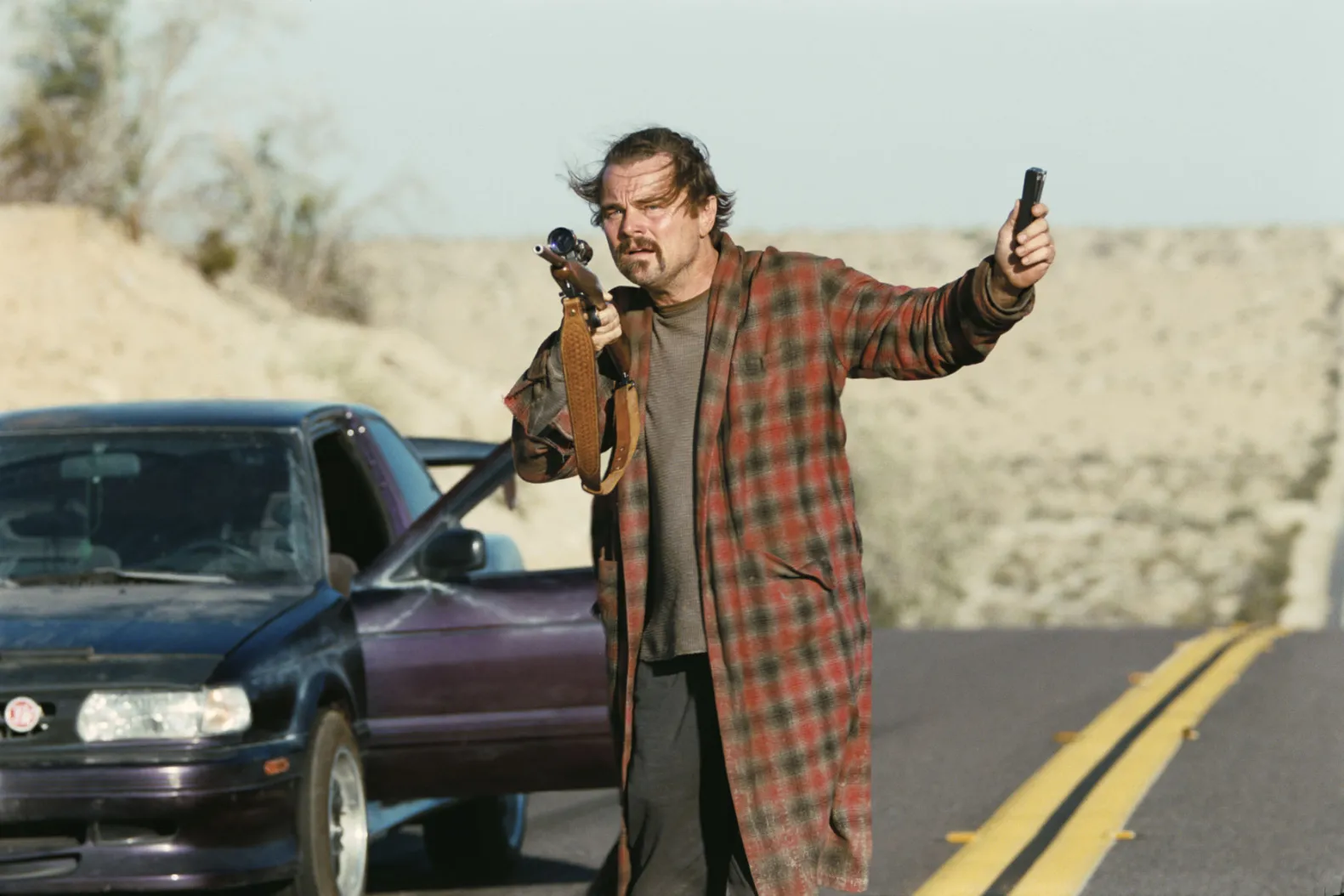 Actor standing beside a car